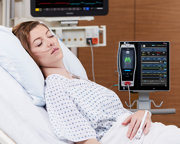Patient wearing cannula with Root monitor displaying capnography parameters