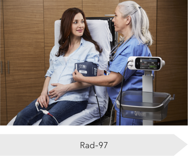 Nurse using the Masimo Rad-97 monitor to check the blood pressure of a pregnant patient, demonstrating clinical use in maternal care.